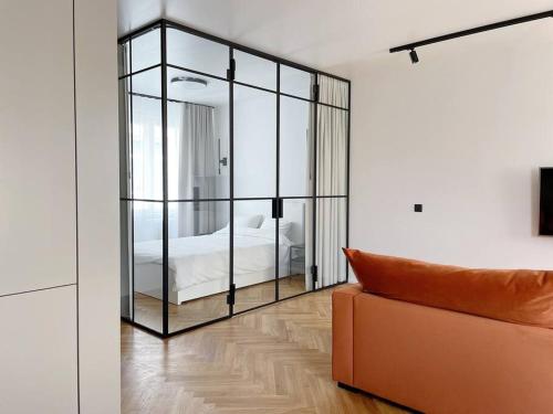 a bedroom with a glass partition with a bed at New Chic & Minimal Old Town Flat in Kuressaare
