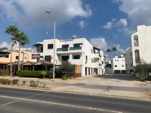a white building on the side of a street at Theodoros Apt.79 in Paralimni