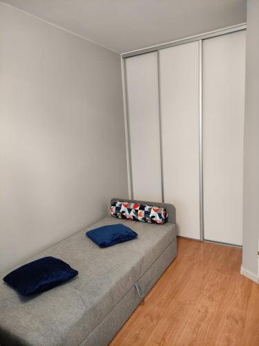 a bedroom with a bed with two pillows on it at Apartament Jagiełły 14 in Giżycko