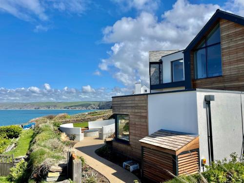 a house with a view of the ocean at The Old Coastguard Lookout in Port Isaac