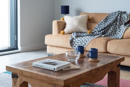 a living room with a coffee table and a couch at The Old Coastguard Lookout in Port Isaac