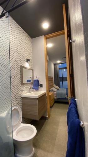 a bathroom with a toilet and a sink at REVU 519 in Tepic