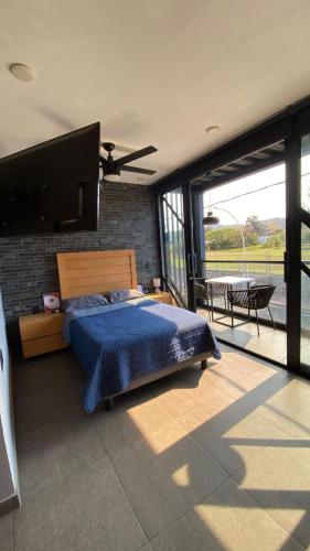 a bedroom with a bed and a large window at REVU 519 in Tepic