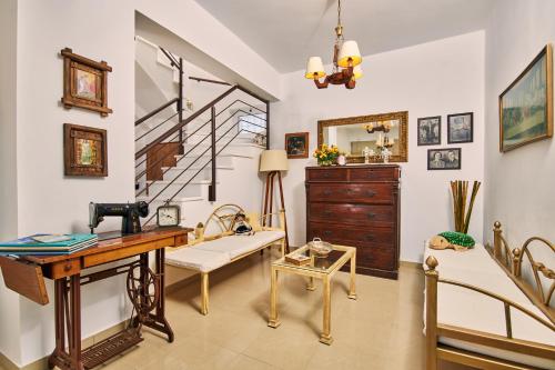 a living room with a desk and a staircase at Villa Contessa Irini in Plános