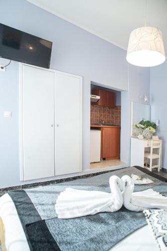 a bedroom with a bed with two white towels on it at Hotel Pithari in Agia Triada