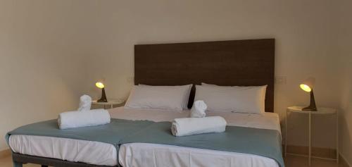 a bedroom with a large bed with two towels at Casa Andrea Teror in Teror