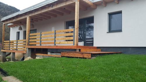 a house with a wooden deck on the side of it at Apartmány pod Janovským vŕškom in Plavecký Svätý Mikuláš