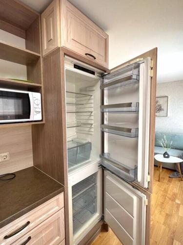 a refrigerator with its door open in a kitchen at New Apartment with a View in the Town Center in Narva