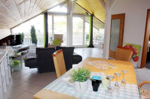 una sala da pranzo con tavolo e un soggiorno di Ferienwohnung Kirschenlohr a Ober-Abtsteinach
