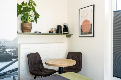 a table and two chairs in a room with a window at B&B Zijlsterkerk in Munnekezijl