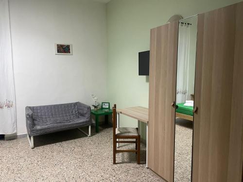 a room with a desk and a chair and a table at Beteyà Hostel Don Bosco in Catania