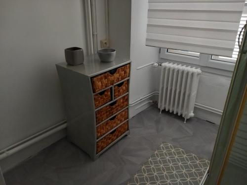 a room with a cabinet with brick drawers and a window at MELANIE in Ahun