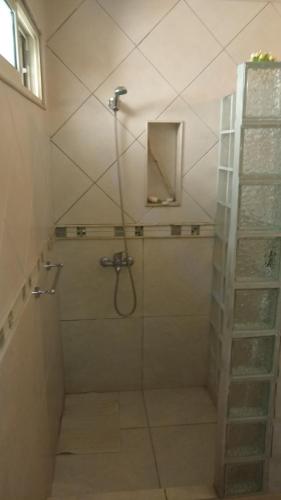 a shower with a glass door in a bathroom at Home J y M in Concordia