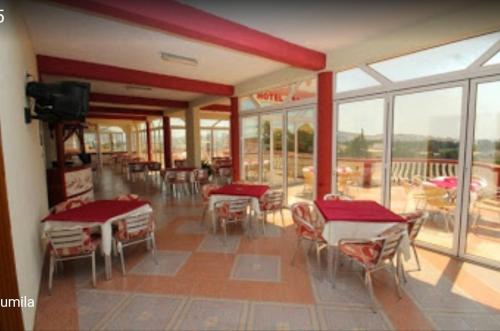 a dining room with tables and chairs and windows at BOGUMILA in Bar