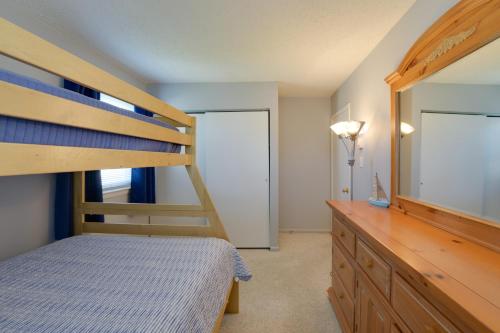 a bedroom with a bunk bed and a dresser at Brigantine Condo with Gas Grill - Walk to Beach! in Brigantine