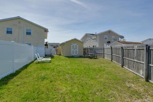 a yard with a fence and some houses at Brigantine Condo with Gas Grill - Walk to Beach! in Brigantine