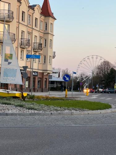 a small sail boat sitting on the side of a street at Warszawska 1 Apartament Giżycko in Giżycko