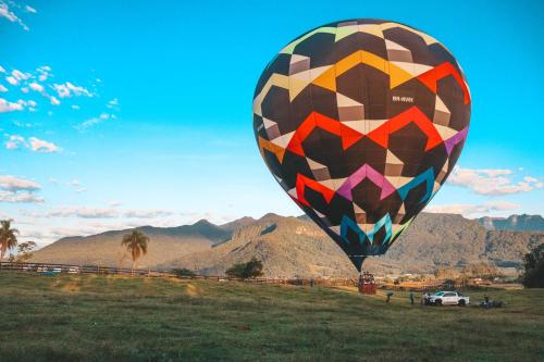 a large colorful hot air balloon in a field at Pousada Di Venezia - Hotel Fazenda in Nova Veneza