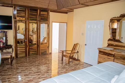 a bedroom with a bed and a desk and a chair at Blue Berry Hill Villa in Discovery Bay
