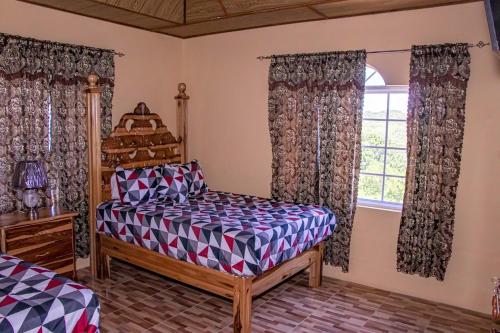 a bedroom with a bed and a window at Blue Berry Hill Villa in Discovery Bay
