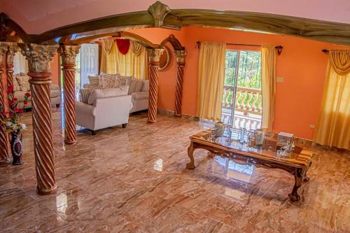 a living room with a table and a couch at Blue Berry Hill Villa in Discovery Bay
