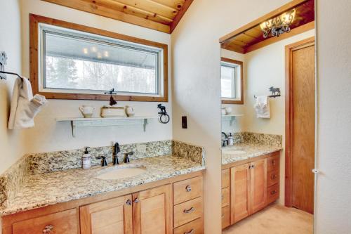 a bathroom with two sinks and a window at Cozy Mountain Home on 10 Acres with Fire Pit and Games in Thayne