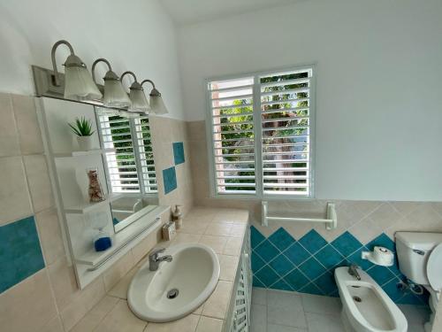 a bathroom with a sink and a toilet and a window at Beautiful 1 Bedroom Apartment in Paradise / WIFI in Las Terrenas