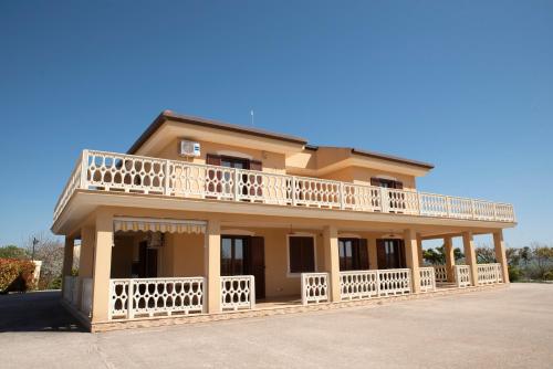 a large house with a balcony on top of it at B&B La Terrazza Degli Scrittori in Racalmuto