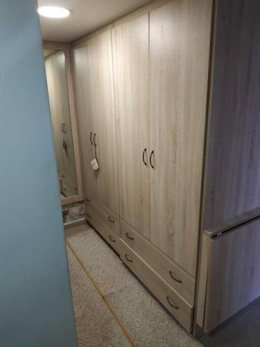 a room with wooden cabinets and a tile floor at Μικρό σαλέ. in Pournára
