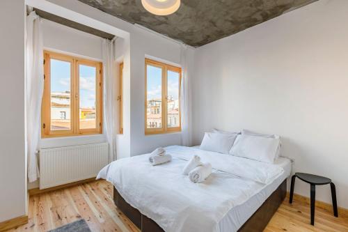 a bedroom with a large white bed with towels on it at Cozy in Istanbul