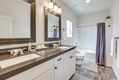 a bathroom with a sink and a toilet and a mirror at Updated Las Vegas House Patio and Solar Heated Pool in Las Vegas