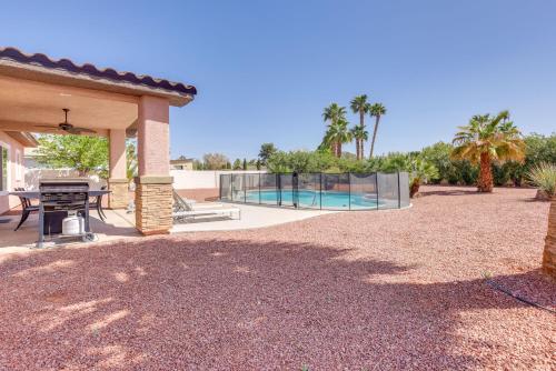 a patio with a table and a swimming pool at Updated Las Vegas House Patio and Solar Heated Pool in Las Vegas