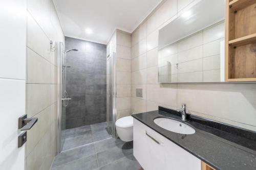 a bathroom with a sink and a toilet and a shower at Modern Apartment with Shared Sauna in Alanya in Kargicak
