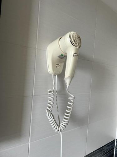a hair dryer hanging on a wall in a bathroom at Cà Dei Barcaroli in Mestre