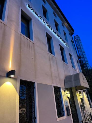 a white building with a sign on the side of it at Cà Dei Barcaroli in Mestre