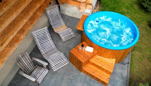 an overhead view of a pool on a table with chairs at Bajkowa Chata 3 Magiczne Domki Jacuzzi in Murzasichle