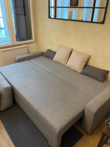 a bed with two pillows on it in a room at Le Charmant Paillot Hyper Centre classé in Troyes