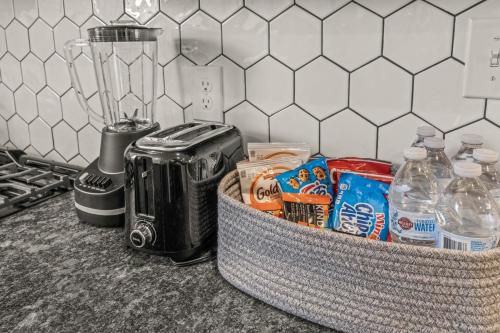 a kitchen counter with a blender and some food at Kid-Friendly Fishtown Family Retreat with Game Room in Philadelphia