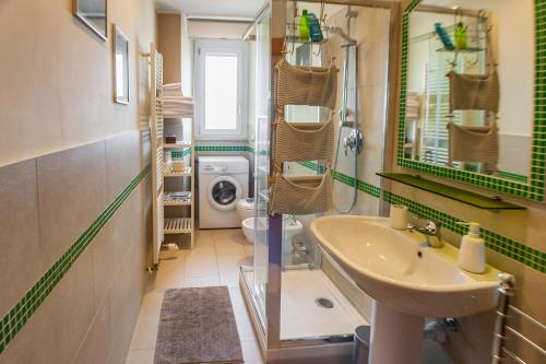 a bathroom with a sink and a washing machine at Attico con Vista in Turin