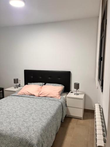 a bedroom with a bed and two night stands at La Caseta del Fai in Riells del Fay