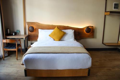 a bedroom with a large bed with a wooden headboard at Taksimbul Design Hotel in Istanbul