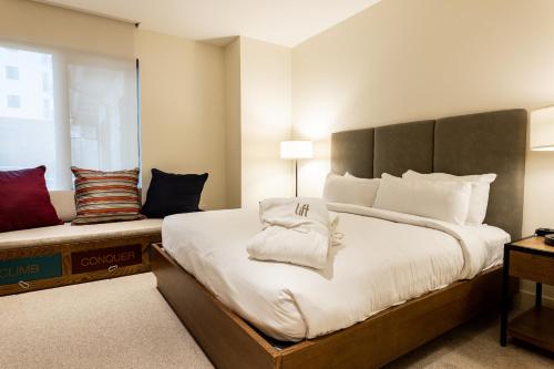 a bedroom with a large bed with white pillows at Lift Park City Condominiums in Park City