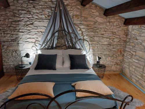 a bedroom with a large bed in a stone wall at Villa Viktor in Labin