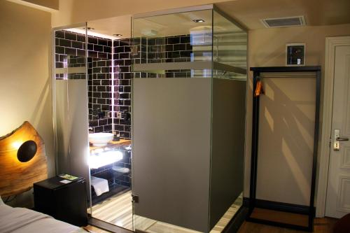 a glass shower door in a room with a bathroom at Taksimbul Design Hotel in Istanbul