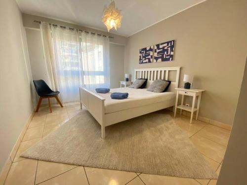 a bedroom with a bed and a chair and a window at free parking, 2min walk to Monaco, 2 rooms, 100 mq in Beausoleil