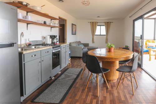 a kitchen with a wooden table and a dining room at EXPERIENCE in Pescadero