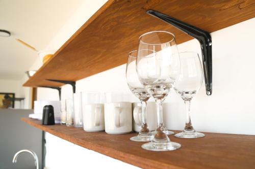 a row of wine glasses sitting on a shelf at EXPERIENCE in Pescadero