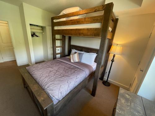 a bedroom with a bunk bed and a lamp at Silver Rock Condominiums by Fernie Central Reservations in Fernie