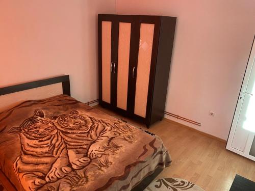 a bedroom with a bed with a tiger design on it at Waves of the Sea in Mangalia