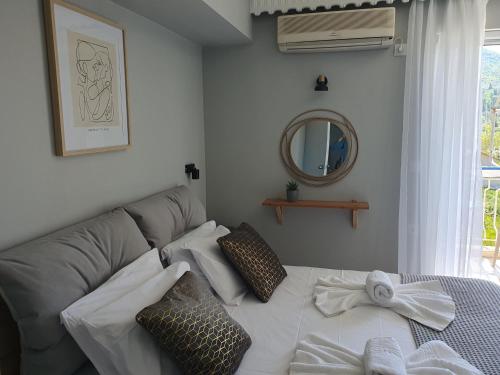 a living room with a couch and a mirror at Mare blu Lefkada in Nydri